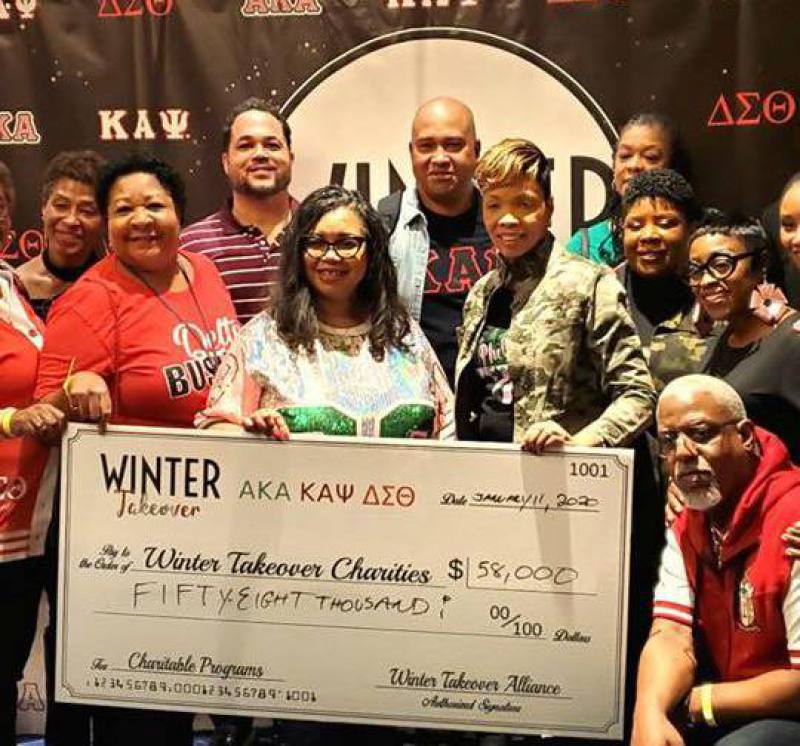 Group Photo of Winter Takeover Participants With Ceremonial Check